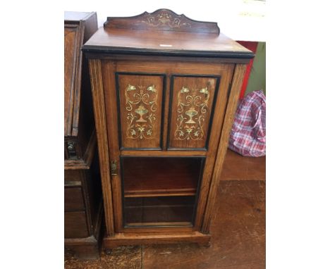 Edwardian inlaid rosewood music cabinet, the panelled door inlaid with glass panel below enclosing adjustable shelves and rai