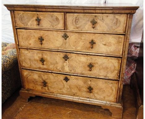 Early 18th century walnut veneered chest of drawers, the top with herringbone crossbanding and concentic circles with oyster 
