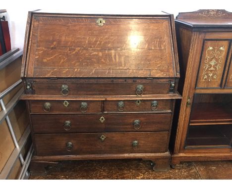 18th century oak bureau with fitted interior and long frieze drawer, two short and two long graduated drawers below with 'D' 