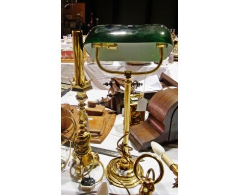 A brass and glass desk light and another brass table lamp on scroll supports 