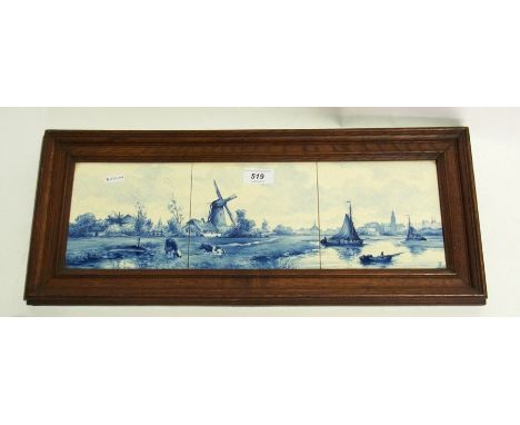 A Delft tile picture, three tiles framed within a wooden frame showing a river scene with windmill and cows to foreground, sa