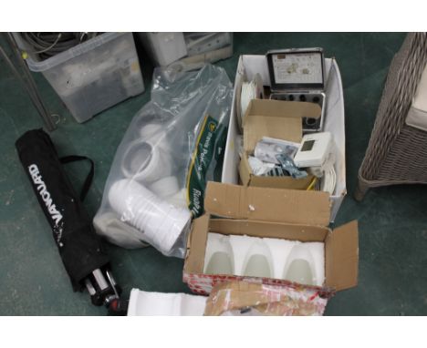 Box of cables, camera tripod, light shades and bag of plumbing pipes