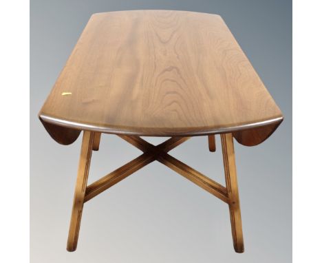 An Ercol elm and beech model 384 drop leaf table 