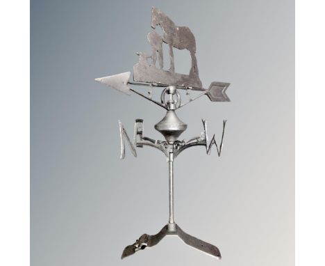 A cast iron farrier with horse weather vane.