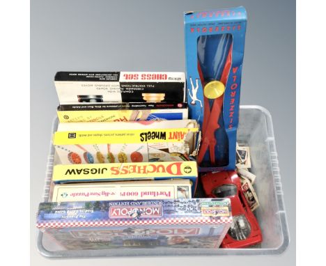 A box of vintage games and jigsaws, Monopoly Sunderland Edition (sealed), die cast Ferrari, tea cards  