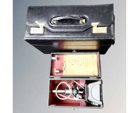 A vintage C Baker of London electric microscope in fitted box together with a leather combination lock briefcase 