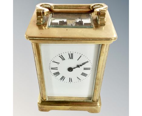 A brass cased carriage timepiece with platform escapement and white enamel dial. (height 14cm)