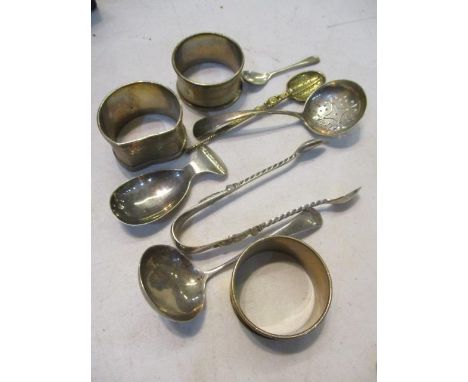 A small mixed lot of silver to include a caddy spoon, napkin rings and sugar tongs 