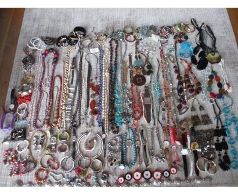 A large quantity of retro and modern costume jewellery and watches to include chunky wooden bead necklaces, metallic belts, a