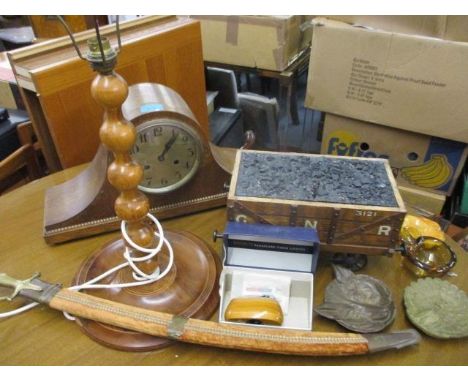 A cigarette box in the form of a train carriage, a mid 20th century cased mantle clock, a table lamp and a display sword 