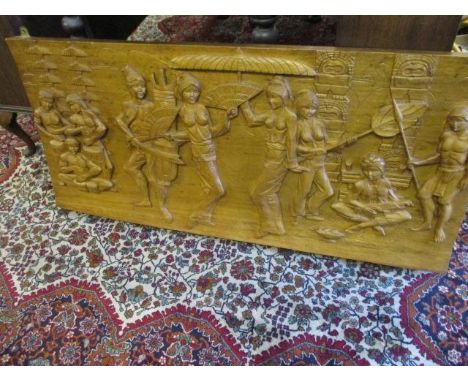 A South East Asian carved hardwood panel depicting scenes from a feast 