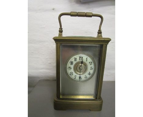 An early 20th century five window brass cased carriage clock with a gong strike movement 