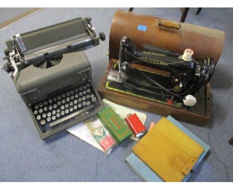 A Singer sewing machine together with an Imperial typewriter and accessories 