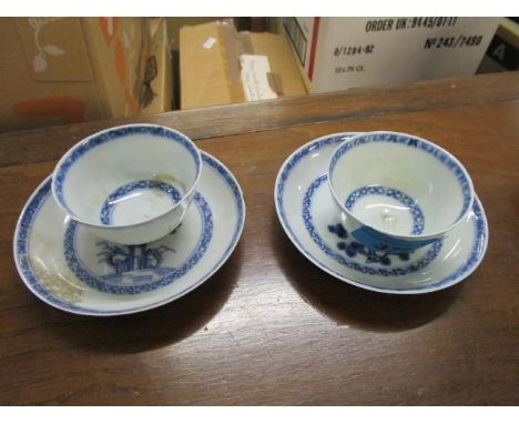 Two Nanking cargo tea bowls and saucers in blue and white, decorated with trees, label to base 