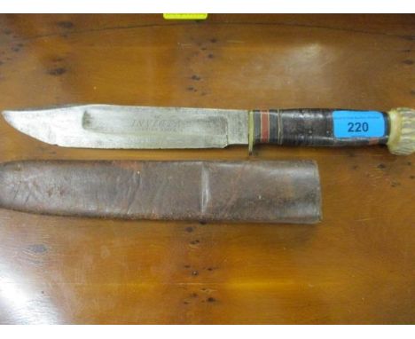 An Invicta hunting knife with a bone handle and leather sheath 