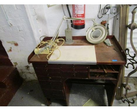 An early 20th century mahogany knee hole work table with a galleried back, 8 graduated drawers, along with a vintage Alken la