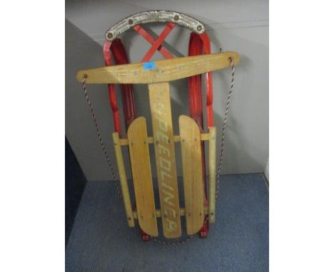 A vintage American 'Speedliner' red metal and wooden sledge 