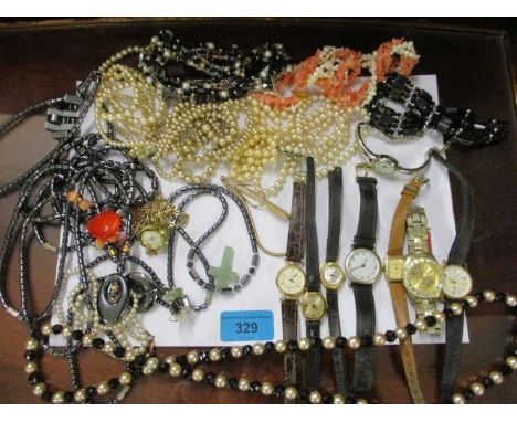 A quantity of costume jewellery and wristwatches to include Timex 