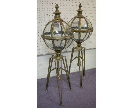 GARDEN LANTERNS, a pair, with a turned finial and an orb shaped top with glazed panels on a tripod support, 97cm H. (2)