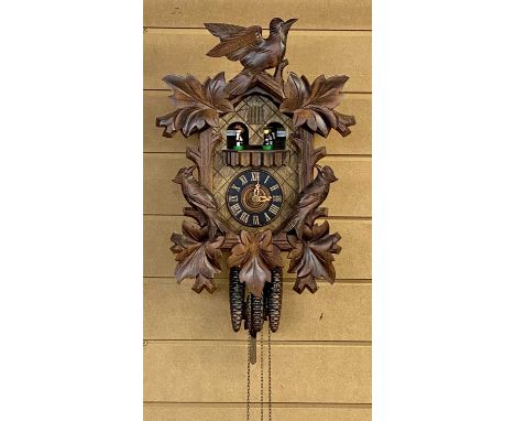 BLACK FOREST CUCKOO CLOCK 20th century with bird and leaf surmount, musical movement with figures, triple weights, 43cms (h)P