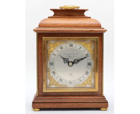 A 20th century walnut cased Elliott mantle clock, with brass swing handle, the brushed metal chapter ring with black Roman nu