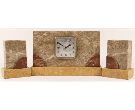 A 1920s Art Deco marble mantel clock with garniture, having an 8 day manual movement.