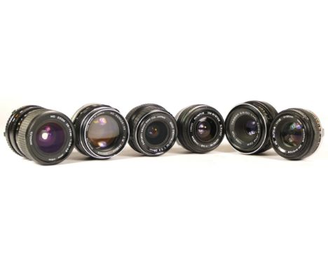 Six assorted camera lenses comprising of Carl Zeiss Jena Tessar 2.8/50, Pentax-M 1:3.5 28mm, Olympus OM-System Zuiko 1:1.8 f=