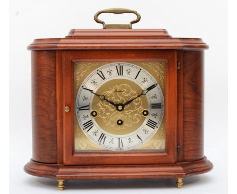 A 20th century Rapport walnut cased cartouche shaped striking mantle clock, with swing carrying handle, the brass engraved di
