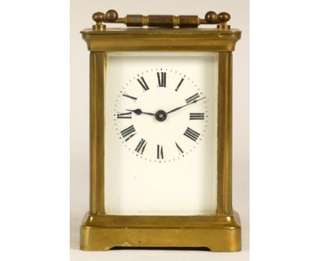 A 20th century brass cased arch topped and four glass corniche cased mantle clock, the brass chapter ring with black Arabic n