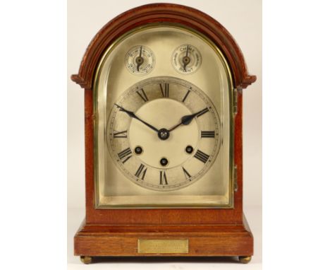 An early 20th century German mantel clock, chiming the quarters and hours, in mahogany round topped case, with silvered dial 