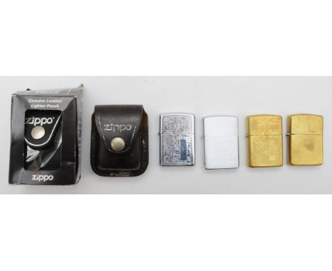 Four Zippo cigarette lighters, pocket petrol filled, together with two Zippo leather lighter pouches. (6) 
