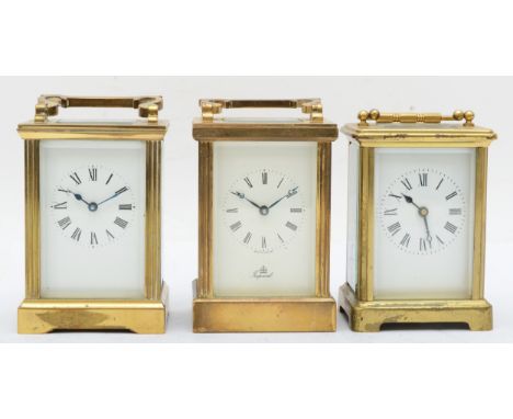 A 20th century Imperial brass and four glass corniche cased carriage clock, the white dial with black Roman numerals raised o