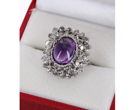 18ct white gold amethyst and diamond cluster ring, with a central amethyst cabouchon  in a surround of round brilliant-cut di