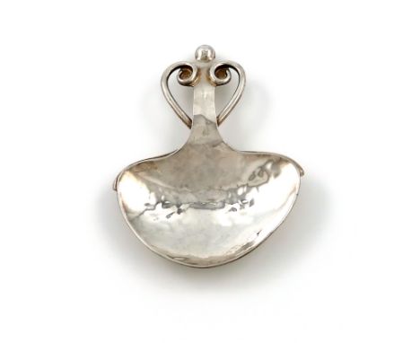 By A. E. Jones, an Arts and Crafts silver caddy spoon, Birmingham 1911, spread heart-shaped bowl, spot-hammered decoration, t