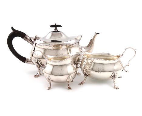 A three-piece Edwardian silver tea set, by William Hutton and Sons, London 1904/5, oval bellied form, scroll handles, gadroon