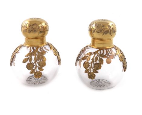 A pair of Victorian silver-gilt mounted glass scent bottles, by George Heath, London 1890, retailed by H. Lewis and Co. New B