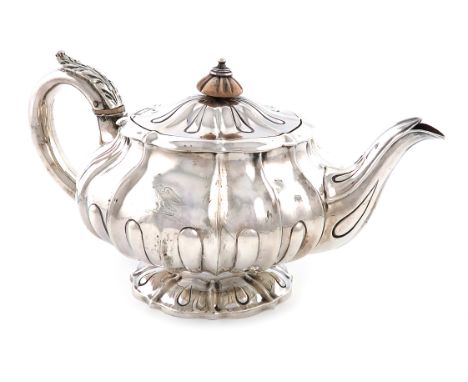 λA George IV silver teapot, by William Eley, London 1824, lobed circular bellied form, the flush hinged cover with an ivory f