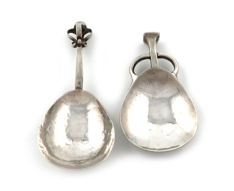 By A. E. Jones, an Arts and Crafts silver caddy spoon, Birmingham 1909, spot-hammered fig-shaped bowl, with a square seal-top