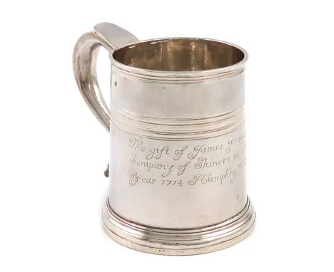A George I silver mug, by Timothy Lee, London 1714, tapering circular form, scroll handle, reeded girdle above an inscription