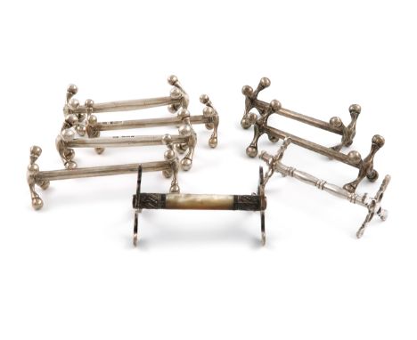 A collection of eight silver knife rests, comprising: a Victorian pair, by Atkin Bros, Sheffield 1897, plain form with ball f