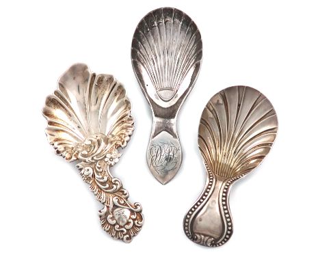 A small collection of three antique Sheffield made silver caddy spoons, comprising: a Victorian one by Martin, Hall and Co., 