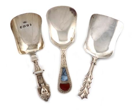 A small collection of three silver caddy spoons, comprising: a Victorian one, by Hilliard and Thomason, Birmingham 1879, shel