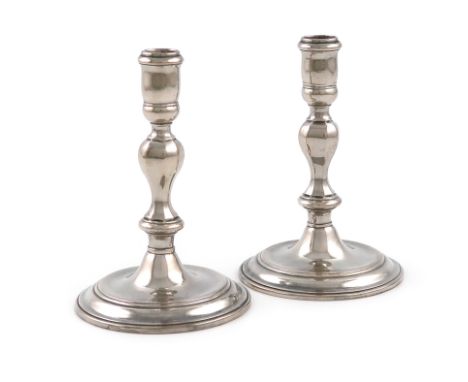 A pair of Queen Anne silver taper sticks, by Jacob Margas, London 1708, octagonal baluster form, spool shaped capitals, on ra