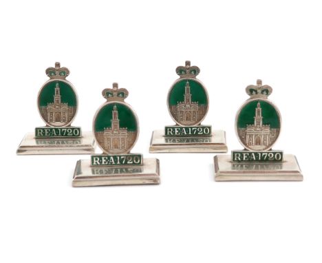 A set of four silver and enamel menu card holders, Birmingham 1919, modelled as the badge of the Royal Exchanged Assurance Co