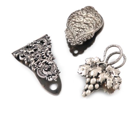 Two silver paper clips, stamped STERLING, one with pierced foliate scroll decoration and one with embossed foliate decoration