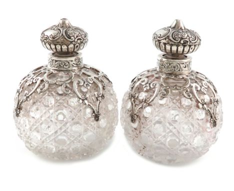 A pair of Victorian silver-mounted cut-glass scent bottles, by J. Rosenthal, London 1892, globular form, hob-nail cut decorat