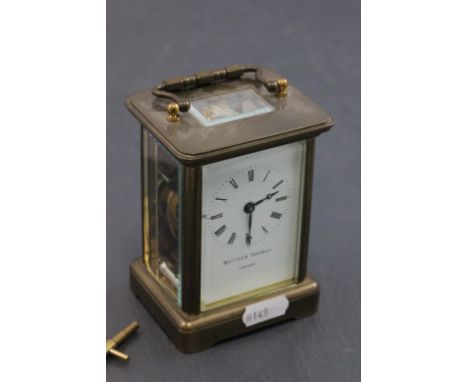 Gilt Brass Carriage Clock, the white enamel face marked Matthew Norman, London with key