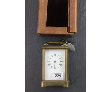 19th century Gilt Brass Carriage Clock, the white enamel face marked Webster & Co in leather travelling case (glass face miss