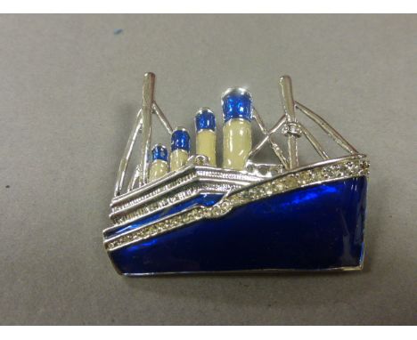 Deco Style White Metal, Blue and Cream Enamel Brooch set with Glass Stones in the form of a Early 20th century Cruise Liner (