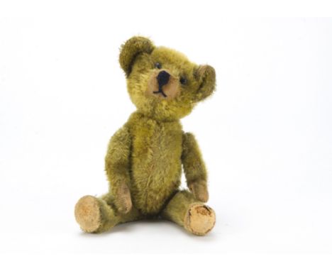 A German teddy bear 1910-20s, with golden mohair, black boot button eyes, re-stitched black nose and mouth, large swivel head